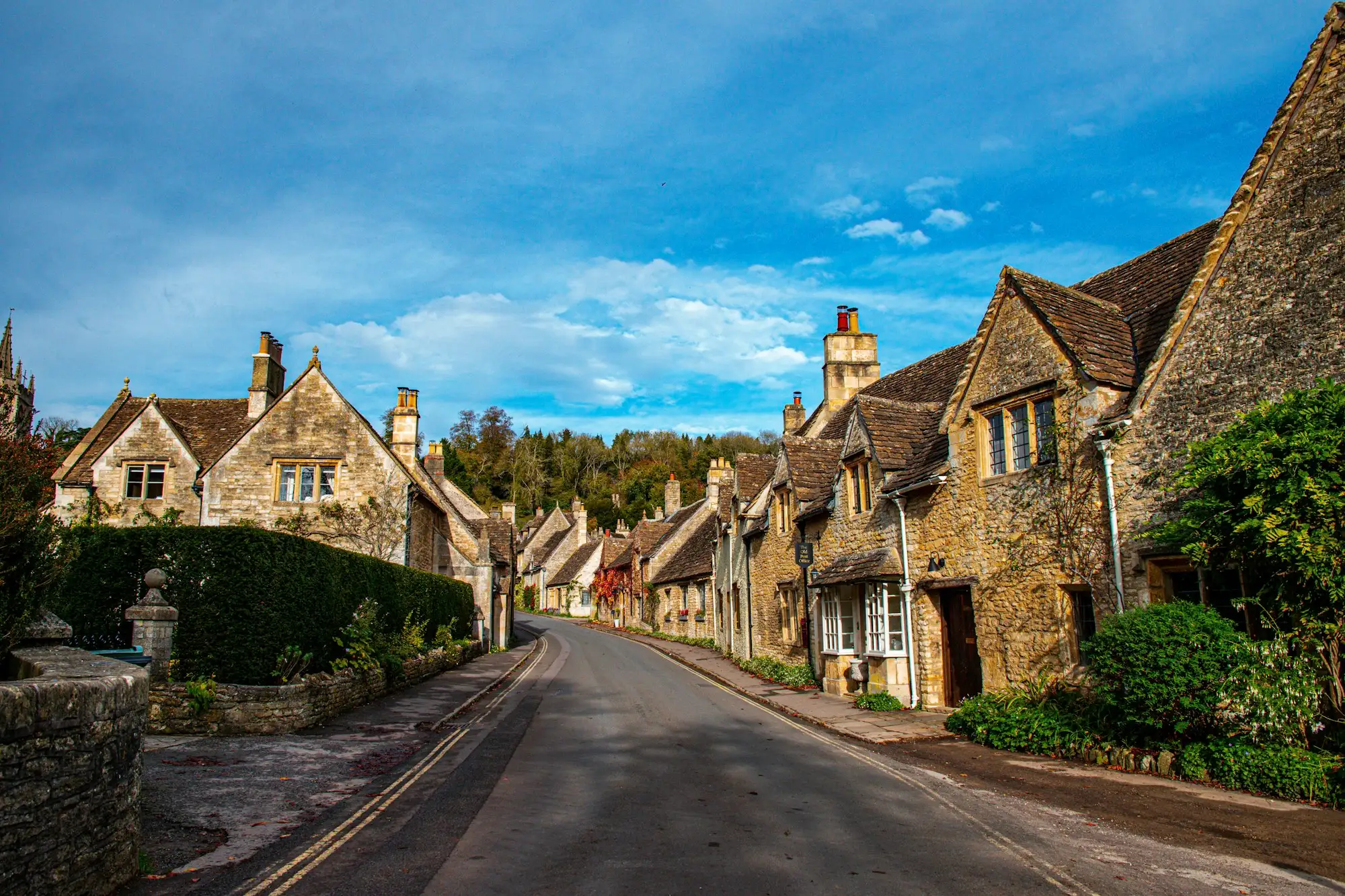A street of old stone houses under a blue sky