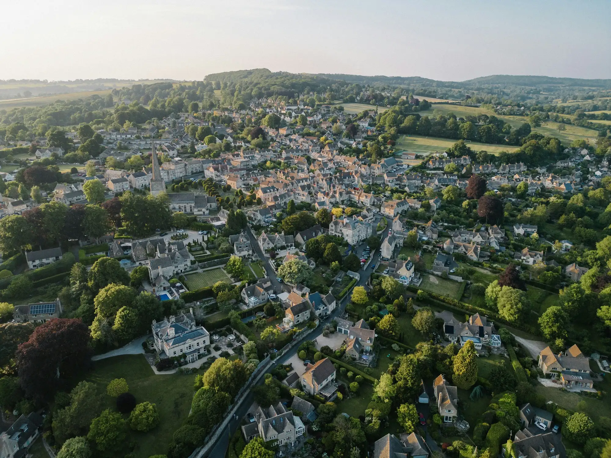 An aerial view of a small town surrounded by trees