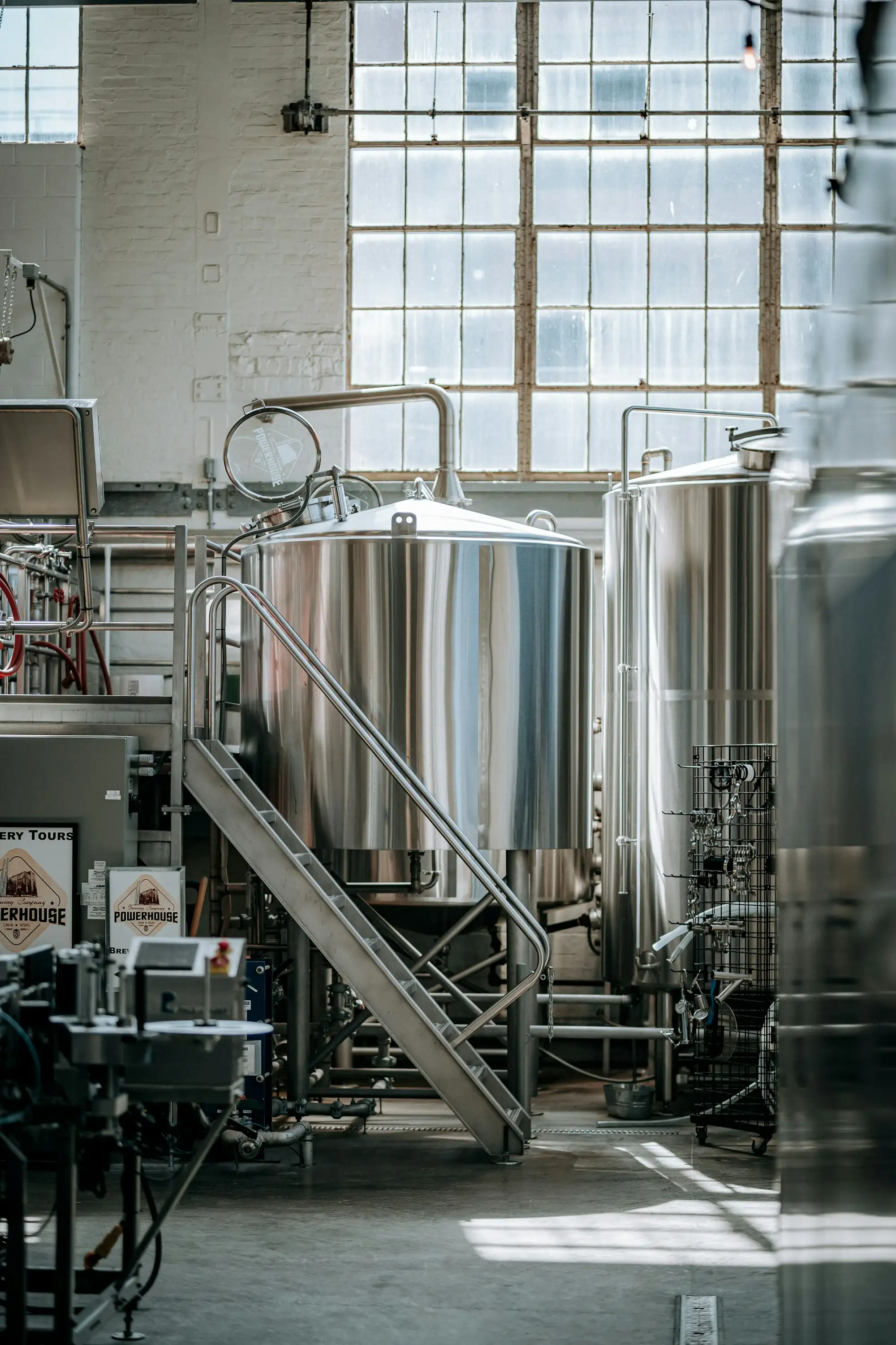 A large room filled with metal fermentation tanks