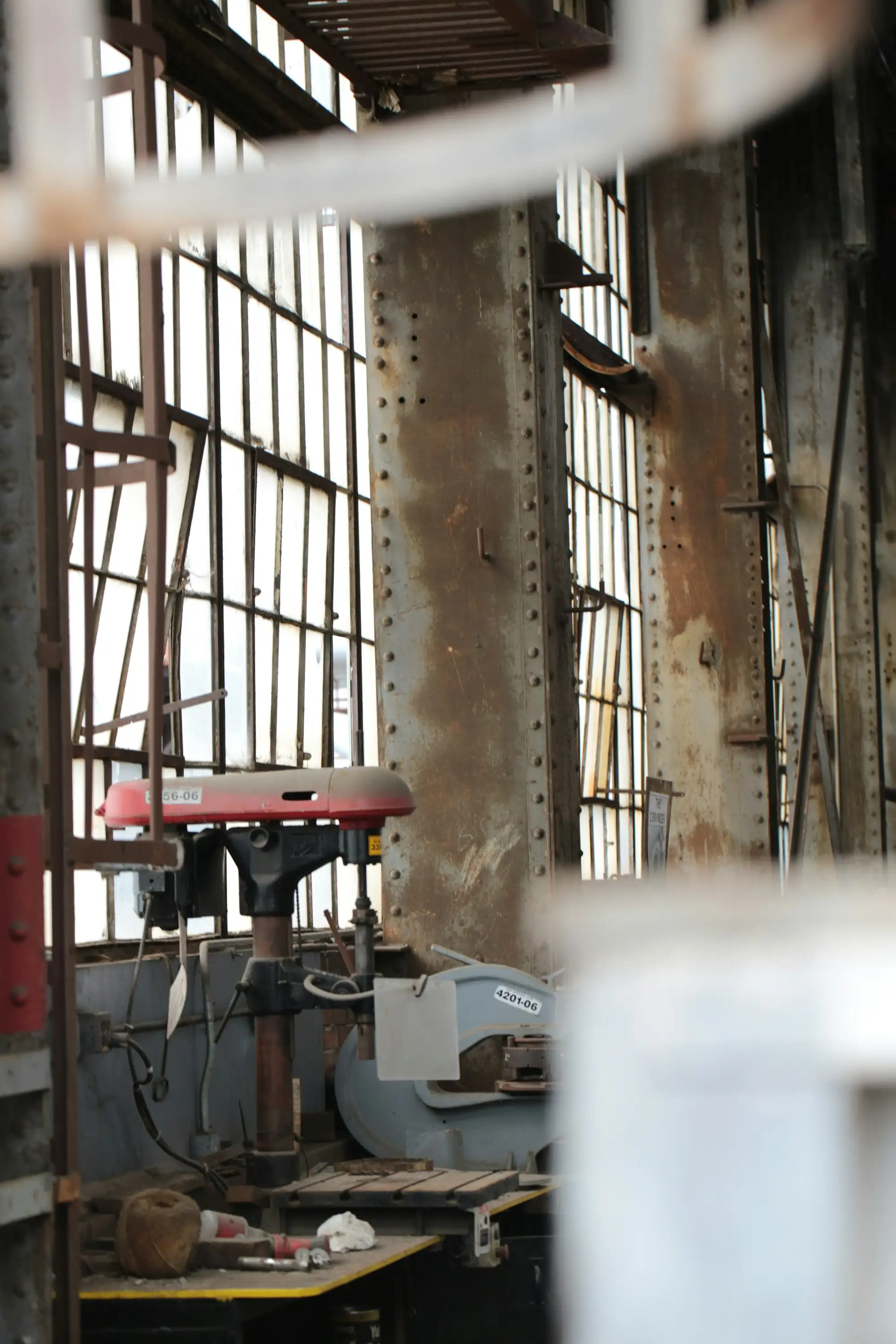 An industrial workshop with machinery and large windows