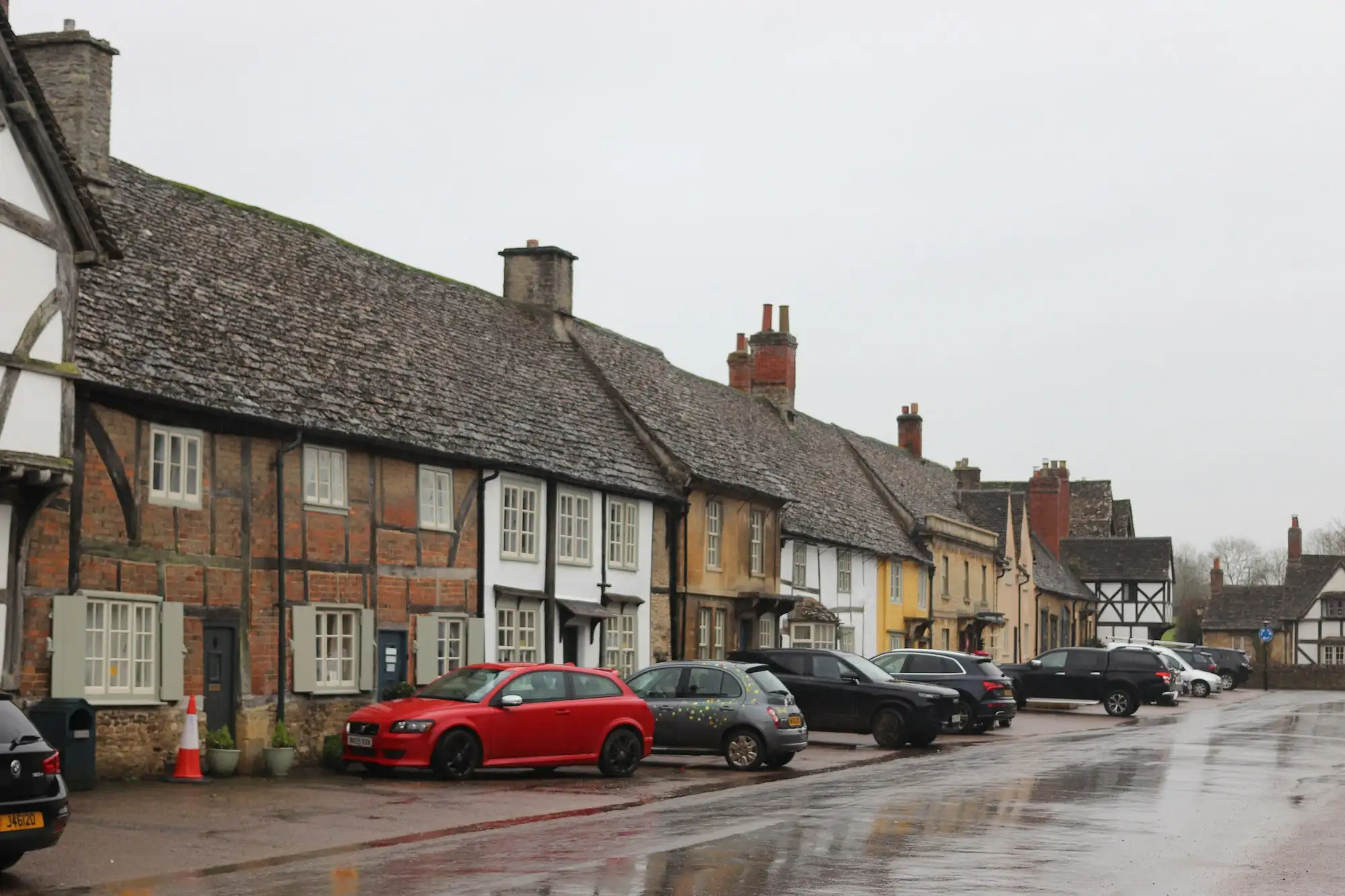 A row of historic buildings with parked cars